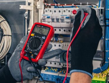 man-electrical-technician-working-switchboard-with-fuses (1)